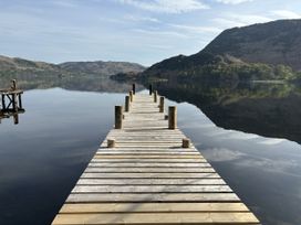 A wooden dock extending over water at Swirral Edge Cottage in Glenridding