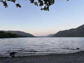 A view of a lake with surrounding mountains at Swirral Edge Cottage in Glenridding