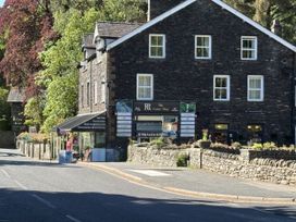 A shop building with signage and trees outside at Swirral Edge Cottage Glenridding