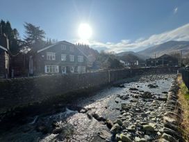 A house near a river with stones at Swirral Edge Cottage in Glenridding