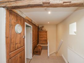 A hallway with a clock and a drawer at High Ickenthwaite Farmhouse in Ulverston