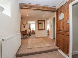 A hallway with a radiator and a mirror at High Ickenthwaite Farmhouse in Ulverston