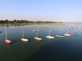 Sailboats anchored in calm water near a grassy shoreline at Plimoth N8 in Yarmouth