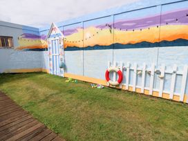 A garden with a painted wall and toys at Plimoth N8 in Yarmouth