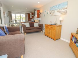 A living room with a sofa and armchair at Plimoth N8 in Yarmouth