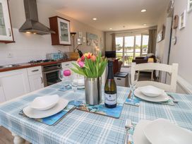 A kitchen with a dining table set at Plimoth N8 Yarmouth