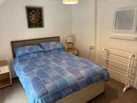 A bedroom with a bed and nightstand at Coedmor in Newport, Pembrokeshire