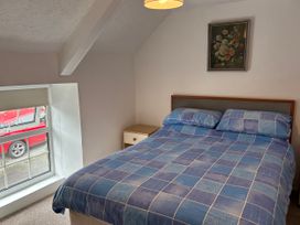 A bedroom with a bed and a window at Coedmor in Newport, Pembrokeshire