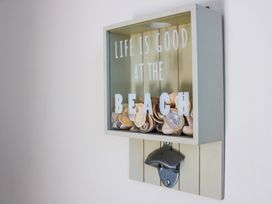 A wall decoration with seashells and a bottle opener at 2 The Elms Salcombe