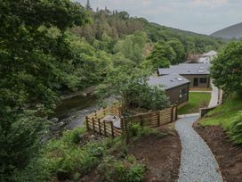 A view of a river along with buildings and trees at Dubs Luxury Family Pod in Keswick