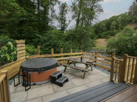 An outdoor space with a hot tub and a picnic table at Dubs Luxury Family Pod in Keswick