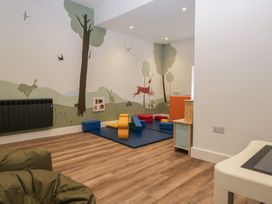 A playroom with colorful blocks and a mural at Lingy Luxury Family Pod in Keswick
