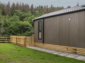A building with a fence and pathway at Sail Luxury Family Pod in Keswick