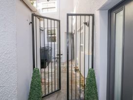 An outdoor area with a gate and planters at Hocking Cottage St Marychurch
