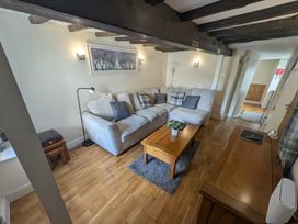 A living room with a sofa and coffee table at Hocking Cottage St Marychurch