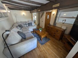 A living room with a sofa and coffee table at Hocking Cottage St Marychurch