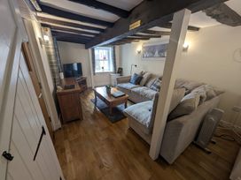 A living room with a sofa and television at Hocking Cottage in St Marychurch