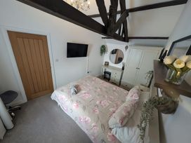 A bedroom with a bed and wardrobe at Hocking Cottage St Marychurch