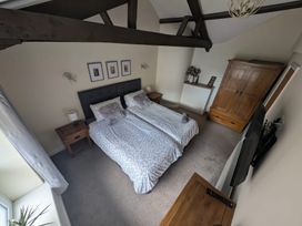 A bedroom with twin beds and a wardrobe at Hocking Cottage St Marychurch