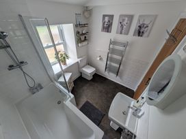 A bathroom featuring a bathtub, shower, toilet, and sink at Hocking Cottage St Marychurch