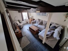 A living room with a coffee table and sofa at Hocking Cottage St Marychurch