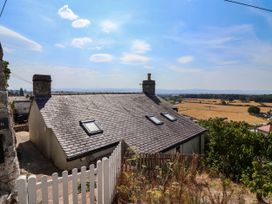 A house with a sloped roof and skylights overlooking fields at Ael Y Bryn in Dyserth