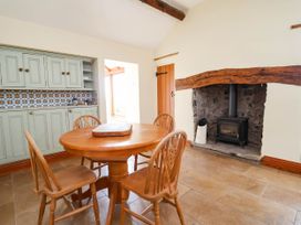 A dining room with a table and chairs at Ael Y Bryn Dyserth