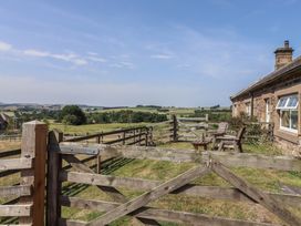 An outdoor area with a fence and chairs at Folly View in Eglingham
