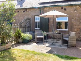 An outdoor seating area with a table and chairs at Folly View in Eglingham