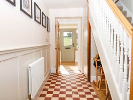 A hallway with a staircase and door at Higher Weekaborough Farm near Coombe Fishacre Ipplepen