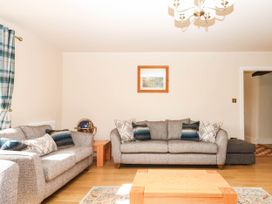 A living room with sofas and a coffee table at Higher Weekaborough Farm in Coombe Fishacre near Ipplepen
