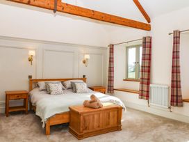 A bedroom with a bed and two nightstands at Higher Weekaborough Farm in Coombe Fishacre near Ipplepen