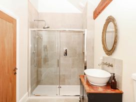 A bathroom with a shower and sink at Higher Weekaborough Farm in Coombe Fishacre near Ipplepen