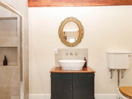 A bathroom with a sink and mirror at Higher Weekaborough Farm near Ipplepen