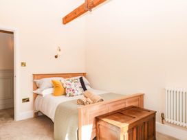 A bedroom with a bed and wooden chest at Higher Weekaborough Farm near Coombe Fishacre near Ipplepen