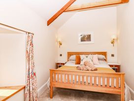 A bedroom with a bed and bedside table at Higher Weekaborough Farm near Coombe Fishacre near Ipplepen