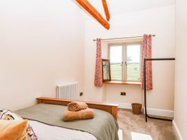 A bedroom with a bed and window at Higher Weekaborough Farm near Coombe Fishacre near Ipplepen