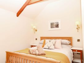 A bedroom with a bed and a picture on the wall at Higher Weekaborough Farm near Coombe Fishacre Ipplepen