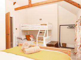 A bedroom with bunk beds and a double bed at Higher Weekaborough Farm near Coombe Fishacre near Ipplepen