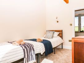A bedroom with two beds and towels at Higher Weekaborough Farm in Coombe Fishacre near Ipplepen