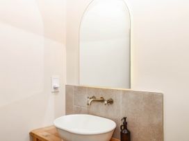 A bathroom with a sink and mirror at Higher Weekaborough Farm Coombe Fishacre near Ipplepen