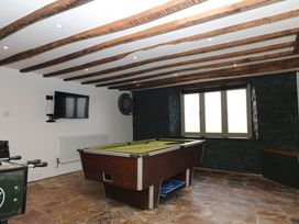 A game room with a pool table and a television at Higher Weekaborough Farm near Coombe Fishacre Ipplepen