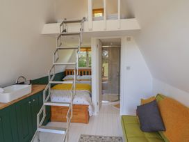 A bedroom with a bed, ladder and shower at A-frame in Monewden near Otley, Suffolk