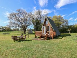 Outdoor area with A-frame cabin and seating at A-frame Monewden near Otley, Suffolk