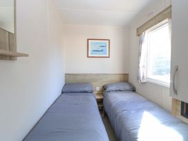 A bedroom with two single beds and a window at 31A Foxburrow Hang in Fritton near Belton Norfolk