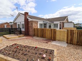 A bungalow with a garden and a flower bed at North Sands in Beadnell
