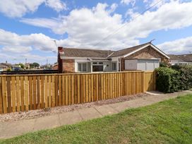 A house with a fence and garage at North Sands in Beadnell
