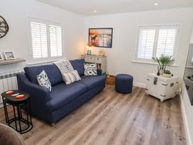 A living room with a sofa and decorative items at North Sands in Beadnell