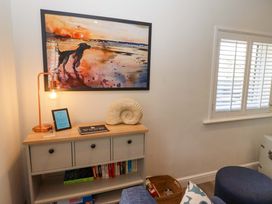 A living room with a table and lamp at North Sands in Beadnell