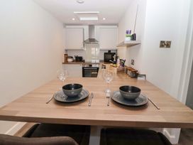 A kitchen with a dining table set for two at North Sands in Beadnell